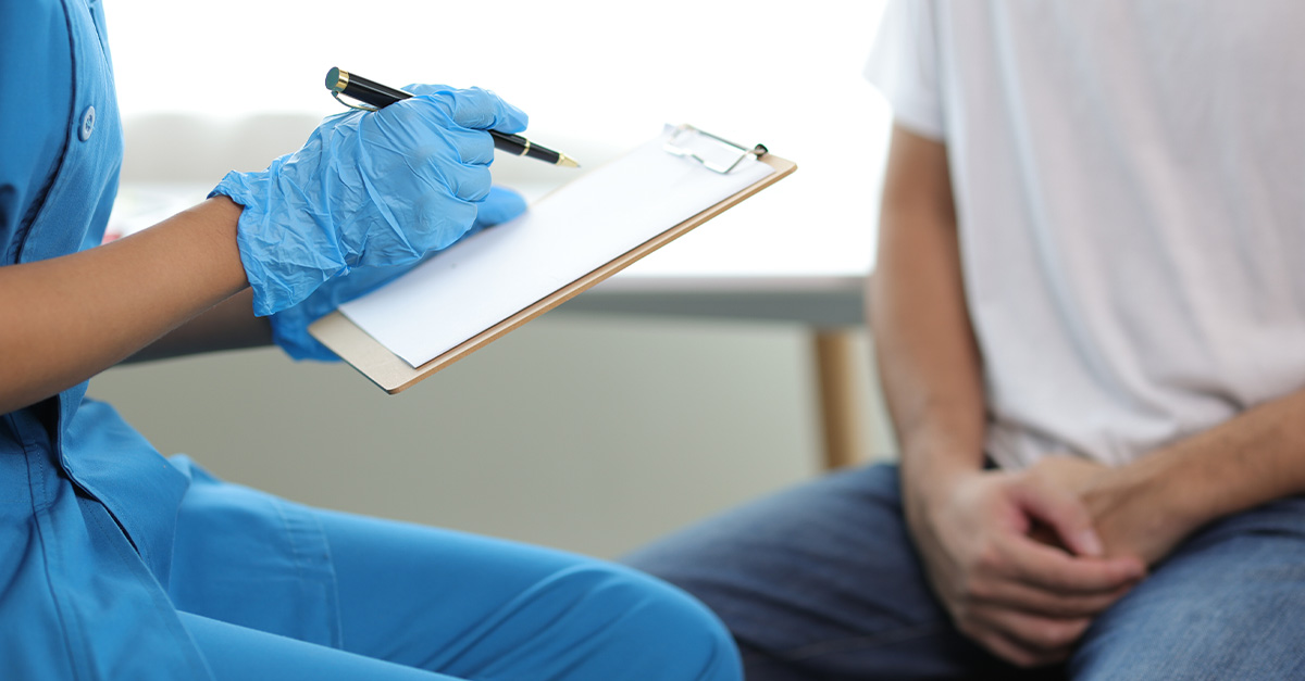 A doctor speaking to male patient about prostate cancer risks.